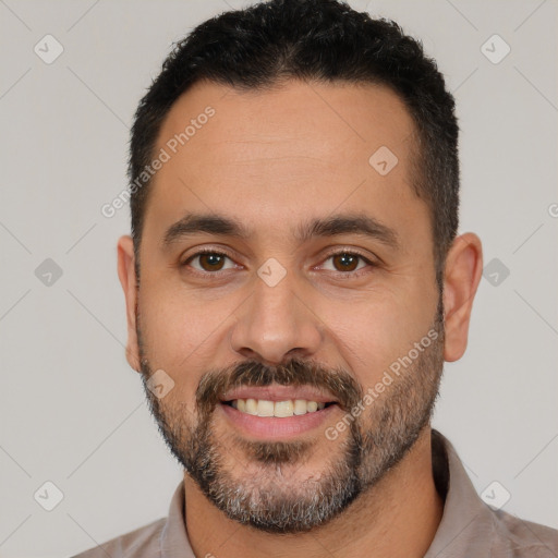 Joyful white young-adult male with short  black hair and brown eyes