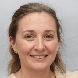 Joyful white adult female with medium  brown hair and brown eyes