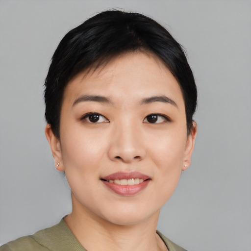 Joyful asian young-adult female with short  black hair and brown eyes