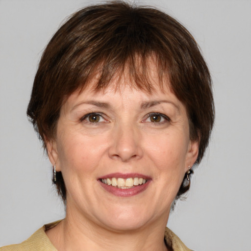 Joyful white adult female with medium  brown hair and grey eyes