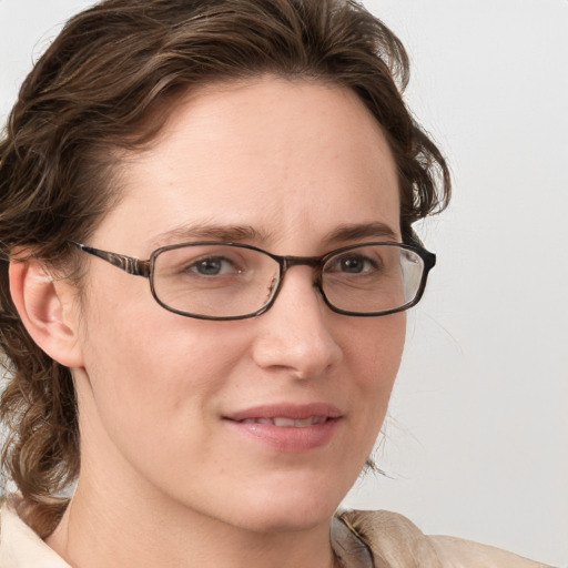 Joyful white young-adult female with medium  brown hair and blue eyes