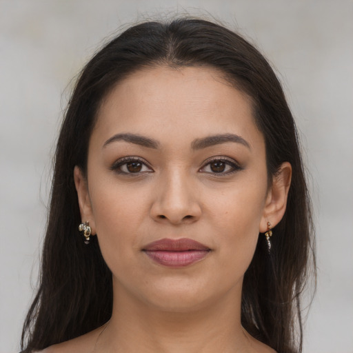 Joyful latino young-adult female with long  brown hair and brown eyes