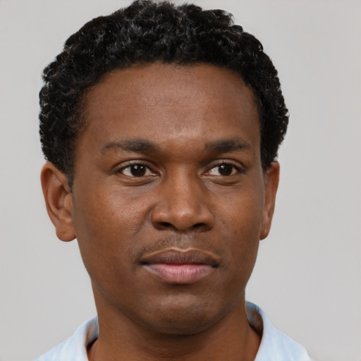Neutral black young-adult male with short  black hair and brown eyes