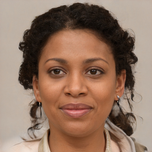 Joyful black young-adult female with medium  brown hair and brown eyes