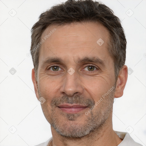 Joyful white adult male with short  brown hair and brown eyes