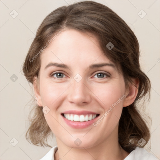 Joyful white young-adult female with medium  brown hair and green eyes