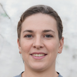 Joyful white young-adult female with short  brown hair and grey eyes