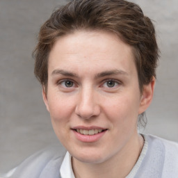 Joyful white adult female with short  brown hair and grey eyes