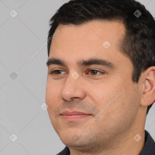 Joyful white young-adult male with short  black hair and brown eyes