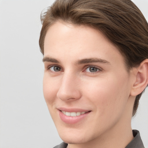 Joyful white young-adult female with short  brown hair and grey eyes