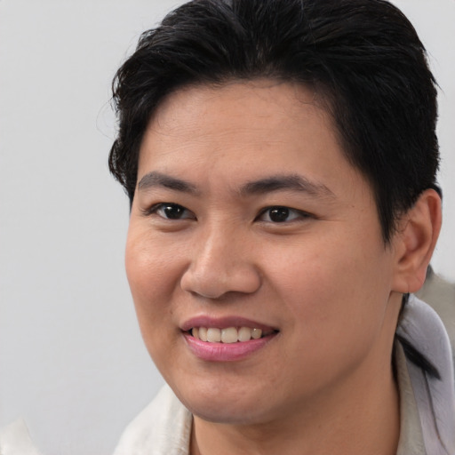 Joyful asian young-adult female with short  brown hair and brown eyes