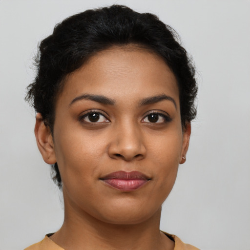 Joyful latino young-adult female with short  brown hair and brown eyes