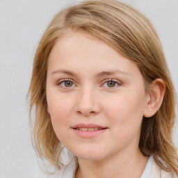 Joyful white young-adult female with medium  brown hair and blue eyes