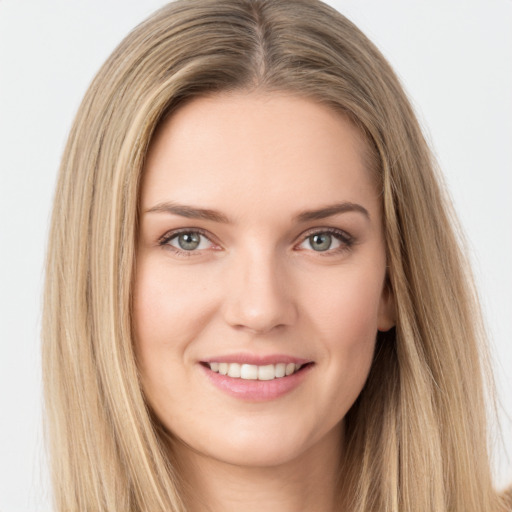 Joyful white young-adult female with long  brown hair and green eyes