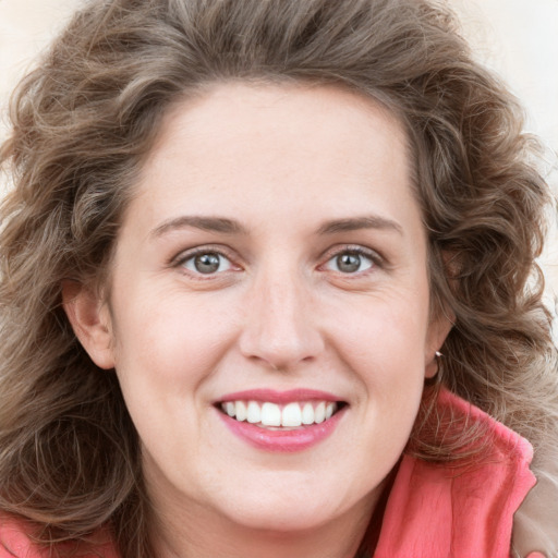 Joyful white young-adult female with long  brown hair and blue eyes