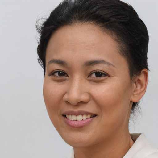Joyful asian young-adult female with short  brown hair and brown eyes