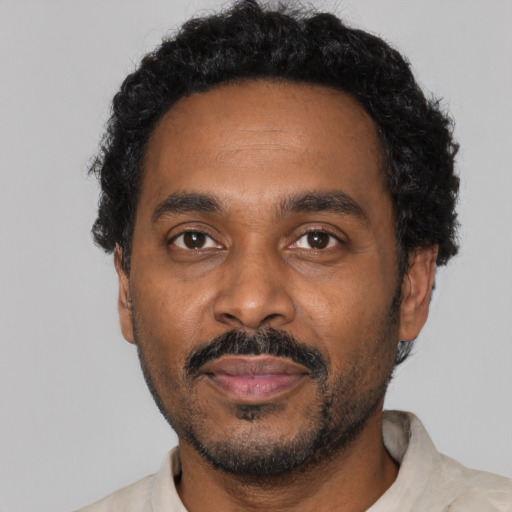 Neutral black adult male with short  black hair and brown eyes