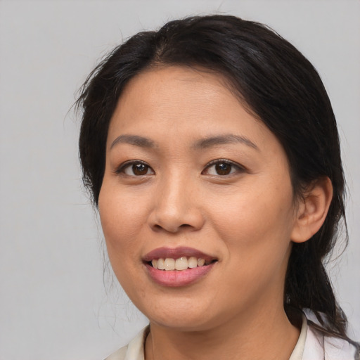 Joyful asian young-adult female with medium  brown hair and brown eyes