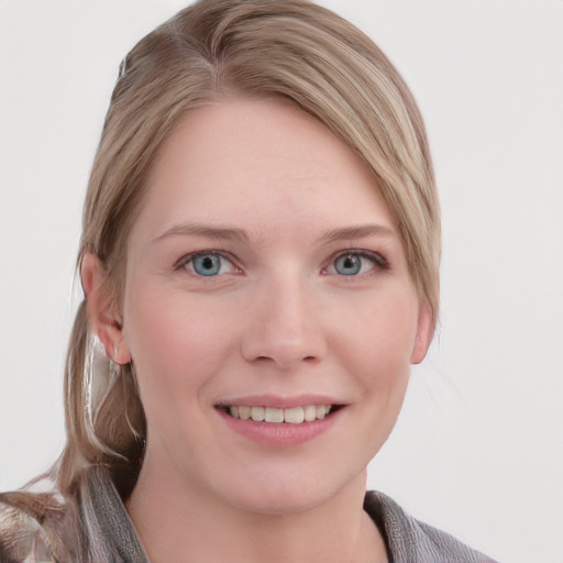 Joyful white young-adult female with medium  brown hair and blue eyes