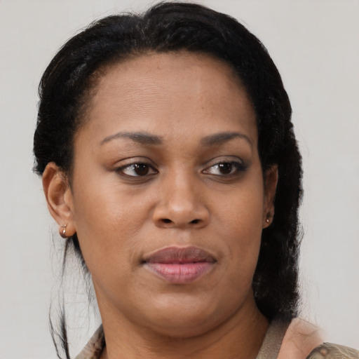 Joyful black young-adult female with medium  brown hair and brown eyes