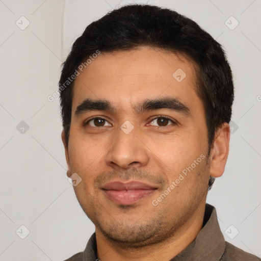 Joyful latino young-adult male with short  black hair and brown eyes