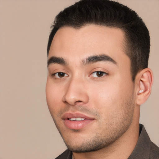 Joyful white young-adult male with short  black hair and brown eyes