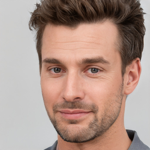 Joyful white young-adult male with short  brown hair and brown eyes