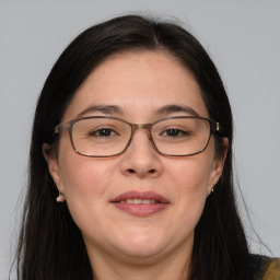 Joyful white adult female with long  brown hair and brown eyes