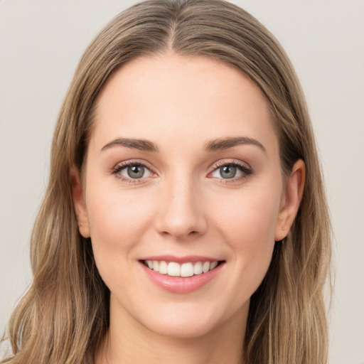 Joyful white young-adult female with long  brown hair and green eyes