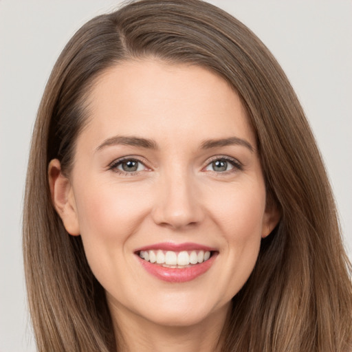 Joyful white young-adult female with long  brown hair and brown eyes