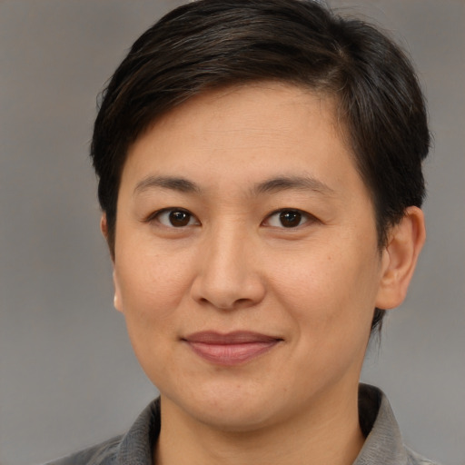 Joyful white adult female with short  brown hair and brown eyes