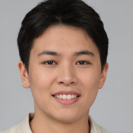 Joyful asian young-adult male with short  brown hair and brown eyes