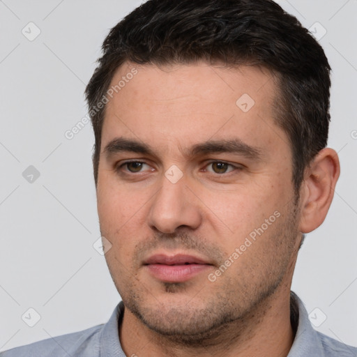 Joyful white young-adult male with short  brown hair and brown eyes