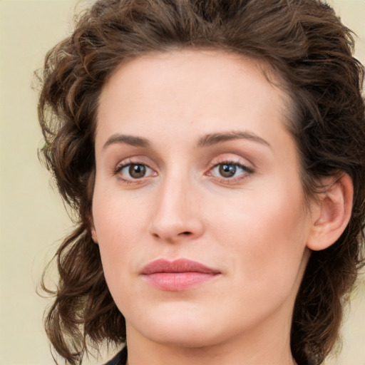 Joyful white young-adult female with medium  brown hair and green eyes