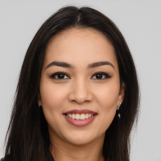 Joyful latino young-adult female with long  brown hair and brown eyes