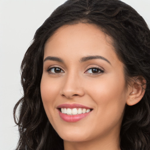 Joyful white young-adult female with long  black hair and brown eyes