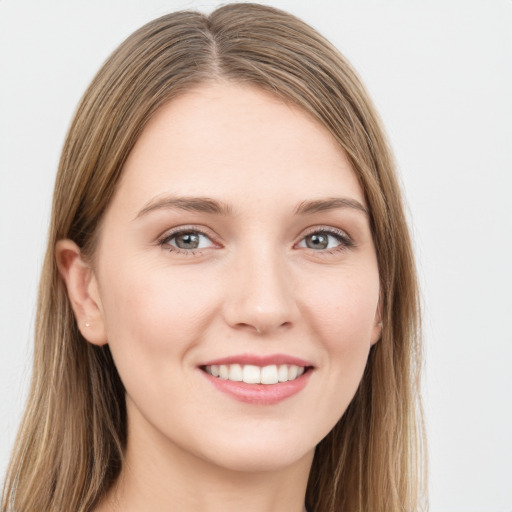 Joyful white young-adult female with long  brown hair and green eyes