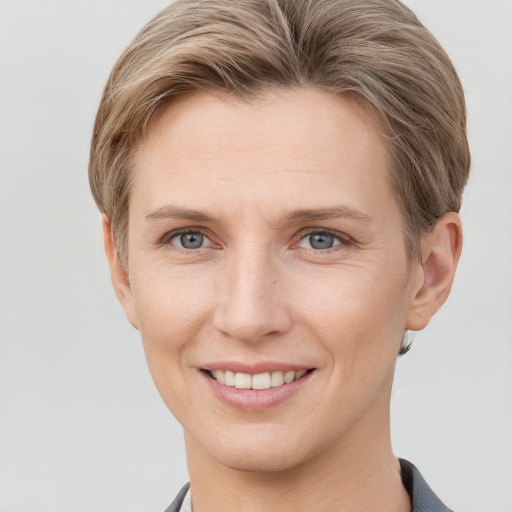 Joyful white young-adult female with short  brown hair and grey eyes