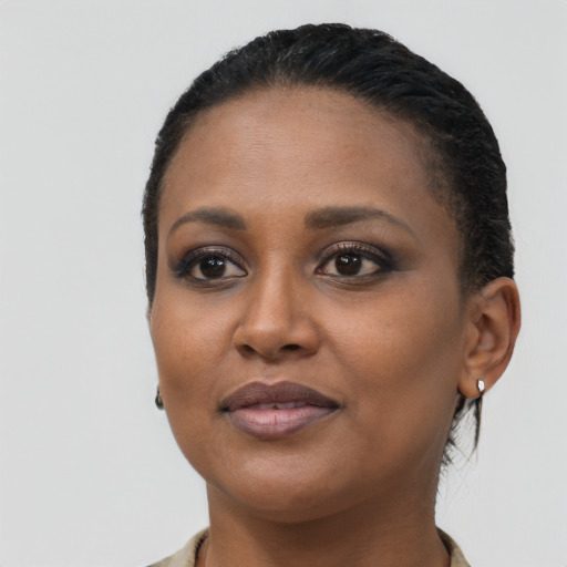 Joyful black young-adult female with short  black hair and brown eyes