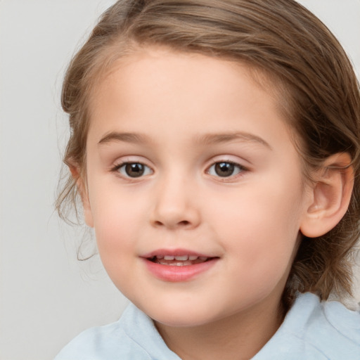 Joyful white child female with medium  brown hair and brown eyes