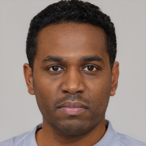 Neutral black young-adult male with short  black hair and brown eyes