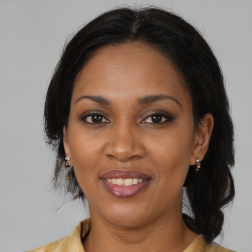 Joyful black young-adult female with medium  black hair and brown eyes