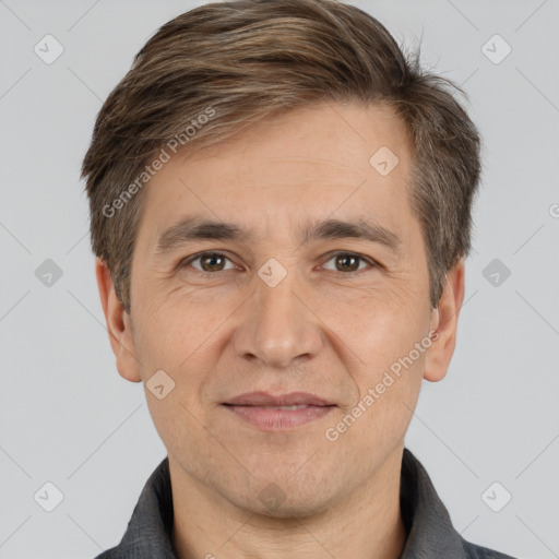 Joyful white adult male with short  brown hair and brown eyes