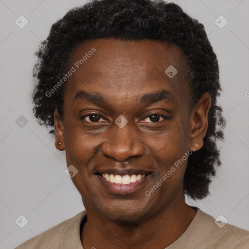 Joyful black young-adult male with short  black hair and brown eyes
