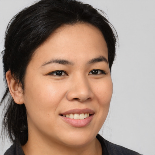 Joyful asian young-adult female with medium  brown hair and brown eyes