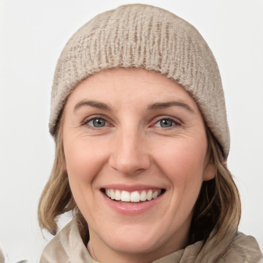 Joyful white young-adult female with medium  brown hair and blue eyes