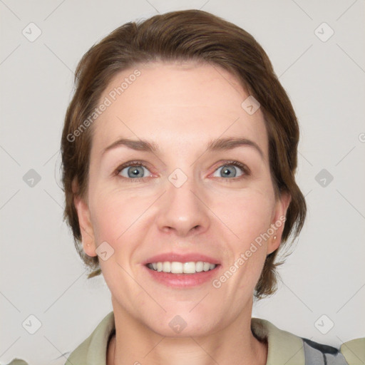 Joyful white adult female with medium  brown hair and grey eyes