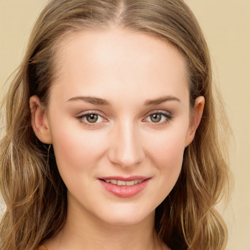 Joyful white young-adult female with long  brown hair and green eyes