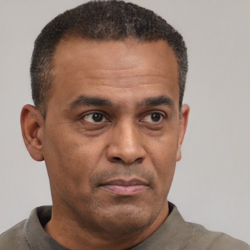 Neutral latino adult male with short  black hair and brown eyes