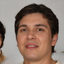 Joyful white adult male with medium  brown hair and brown eyes